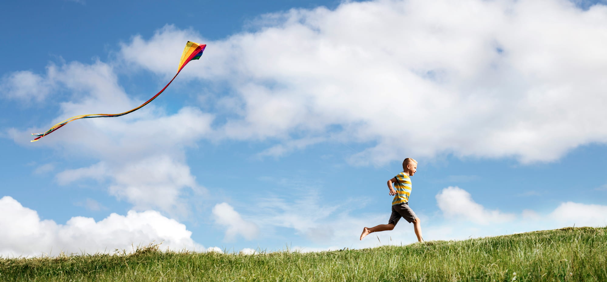 Kid running with kite